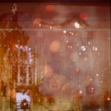 An multi-layered collage of Christmas images. There are hints of trees and lights and baubles and a woman in a fur coat standing in the middle looking at the camera